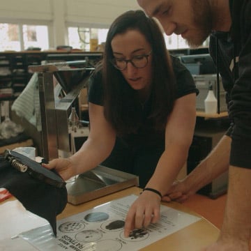 Two staff members in conversation