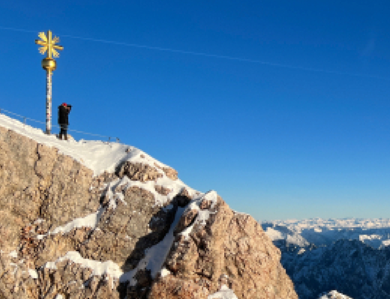 Yuto pictured in the snow next to the summit cross