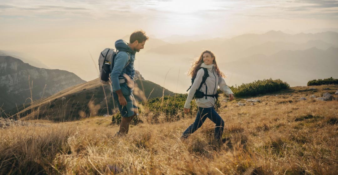 Couple in autumn outdoor clothing in a mountainous area