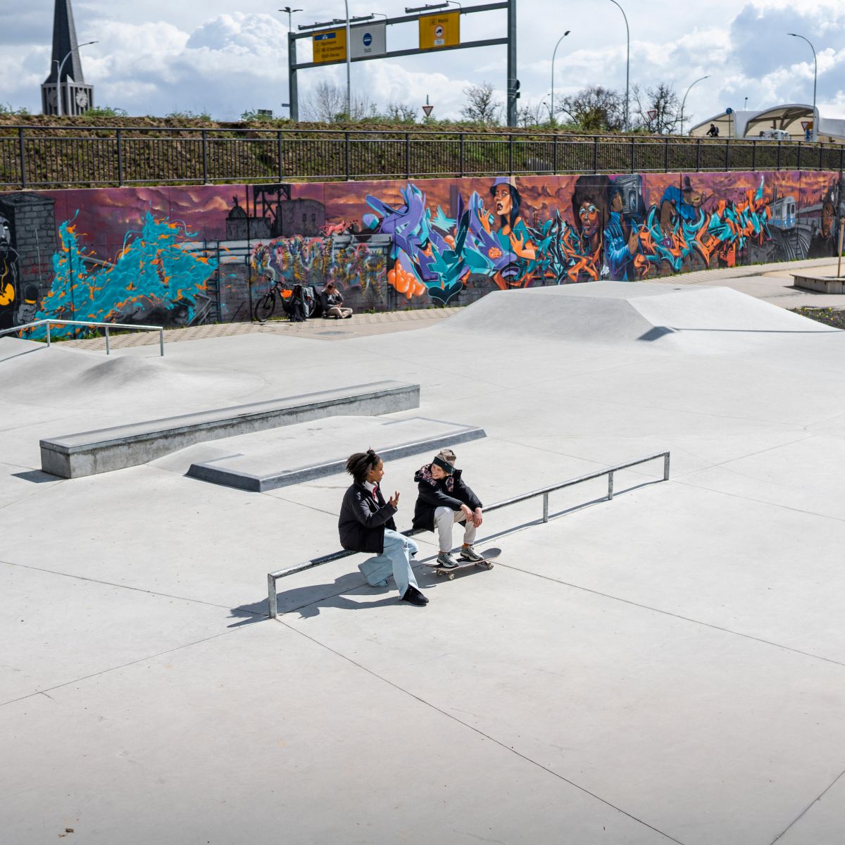 Girl and boy on skateboarding court