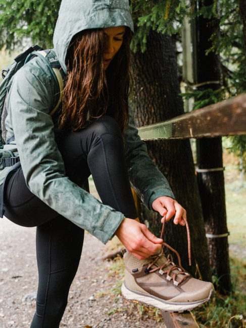 Woman tying up her shoelace
