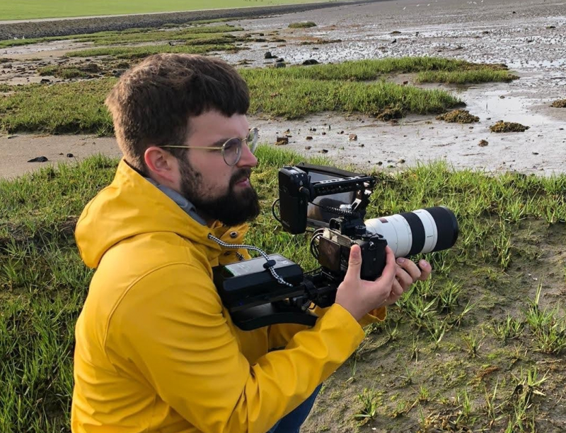 Linus with his camera by the water